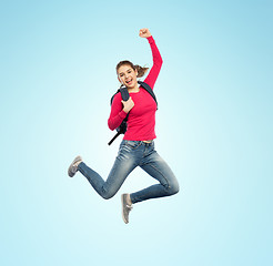 Image showing happy woman or student with backpack jumping