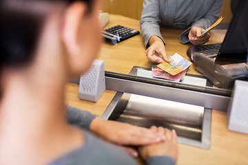 Image showing clerk counting cash money at bank office