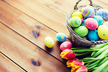 Image showing close up of easter eggs in basket and flowers