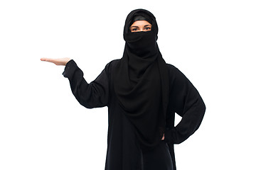 Image showing muslim woman in hijab holding empty hand