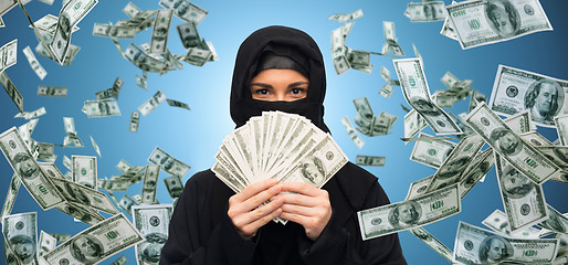 Image showing muslim woman in hijab with money over white