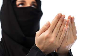 Image showing close up of praying muslim woman in hijab 