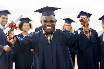 Image showing happy student with diploma celebrating graduation