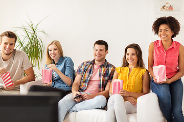 Image showing happy friends with popcorn watching tv at home