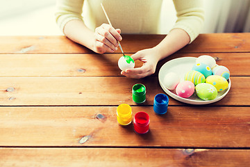 Image showing close up of woman hands coloring easter eggs