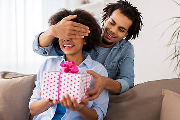 Image showing happy couple with gift box at home