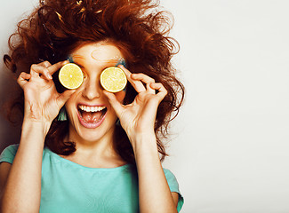 Image showing young pretty girl with orange close up smiling, lifestyle people concept
