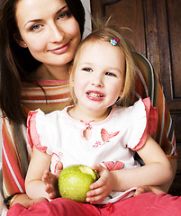 Image showing young pretty stylish mother with little cute daughter hugging, happy smiling family, lifestyle people concept 