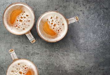 Image showing beer mugs on gray table