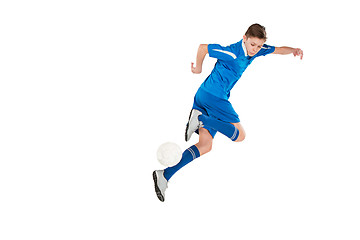 Image showing Young boy with soccer ball doing flying kick