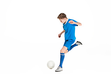 Image showing Young boy with soccer ball doing flying kick