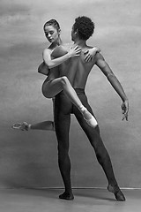 Image showing Couple of ballet dancers posing over gray background