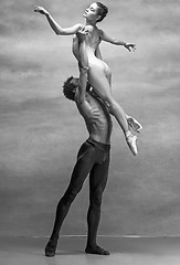 Image showing Couple of ballet dancers posing over gray background