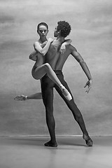 Image showing Couple of ballet dancers posing over gray background