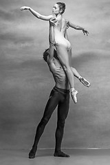 Image showing Couple of ballet dancers posing over gray background