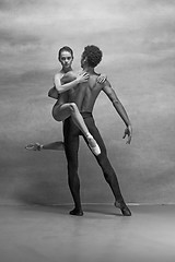 Image showing Couple of ballet dancers posing over gray background