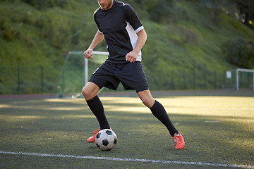 Image showing soccer player playing with ball on football field