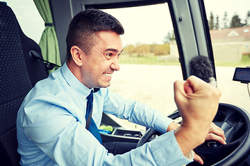 Image showing angry driver showing fist and driving bus