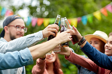 Image showing happy friends clinking glasses at summer garden