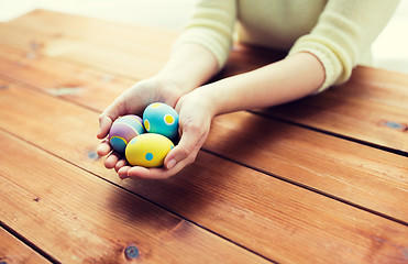 Image showing close up of woman hands with colored easter eggs