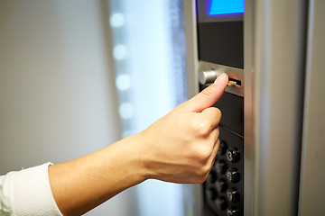 Image showing hand inserting euro coin to vending machine