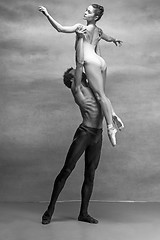 Image showing Couple of ballet dancers posing over gray background