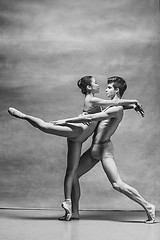 Image showing Couple of ballet dancers posing over gray background