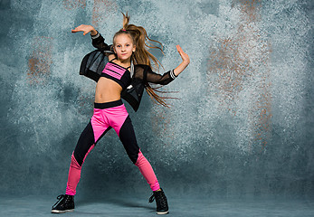 Image showing Young girl break dancing on wall background.