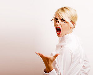 Image showing very emotional businesswoman in glasses, blond hair on white background. teacher hands up posing isolated. pointing gesturing, lifestyle people concept 