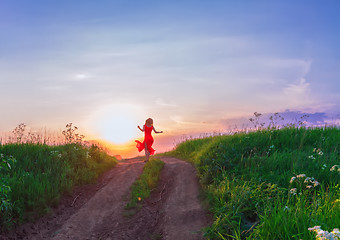 Image showing Young Woman Dancing Against The Sunset