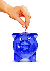 Image showing isolated hand putting coin into piggy bank