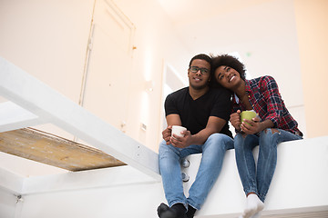 Image showing couple having break during moving to new house