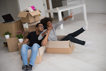 Image showing African American couple  playing with packing material