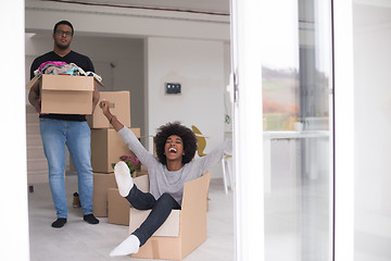 Image showing African American couple  playing with packing material