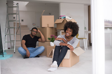 Image showing African American couple  playing with packing material