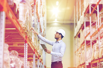 Image showing businessman with tablet pc at warehouse