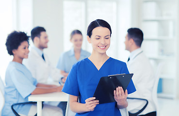 Image showing happy doctor over group of medics at hospital