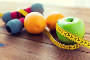 Image showing close up of dumbbell, fruits and measuring tape