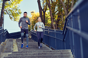 Image showing couple running downstairs in city