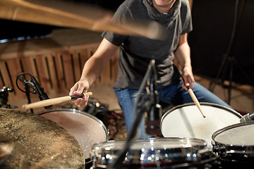 Image showing male musician playing drums and cymbals at concert