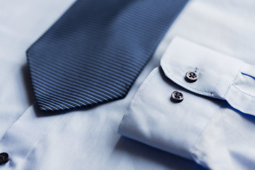 Image showing close up of shirt and blue patterned tie