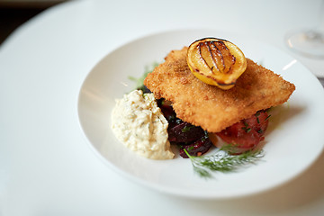 Image showing close up of fish salad with roasted lemon on plate