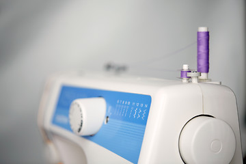 Image showing thread spools on sewing machine