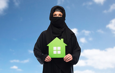 Image showing muslim woman in hijab with green house over white