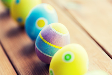 Image showing close up of colored easter eggs on wooden surface