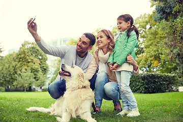 Image showing happy family with dog taking selfie by smartphone