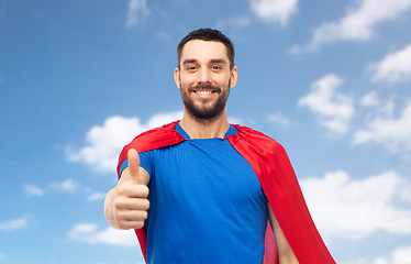 Image showing happy man in red superhero cape showing thumbs up