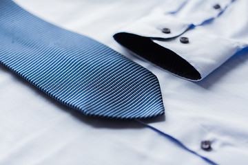 Image showing close up of shirt and blue patterned tie