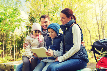 Image showing happy family with tablet pc and backpacks at camp