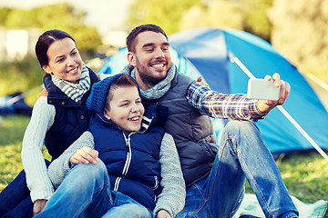 Image showing family with smartphone taking selfie at campsite